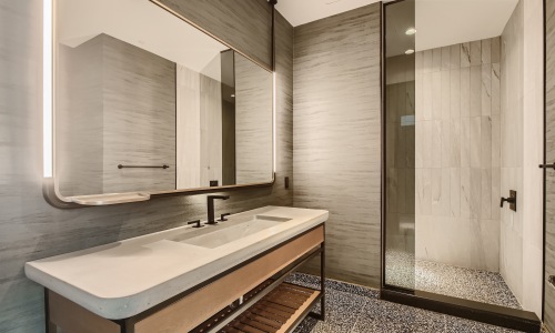 bathroom showing a tub, modern fixtures and wood-style flooring