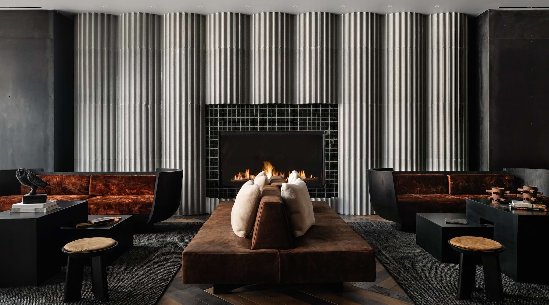 SIENA SETS THE BAR FOR LUXURY LIVING modern room with a fireplace and couches