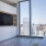 a room with a table and a window with a view of a city