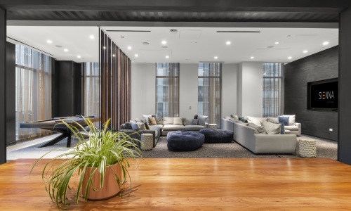 Fourth floor residential business lounge at Sienna at The Thompson featuring modern workspace seating, upscale design, and a comfortable work-from-home environment for residents.