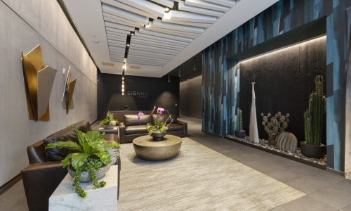 Resident lobby at Sienna at The Thompson featuring designer seating, modern lighting, curated décor, and a sophisticated luxury apartment entrance in Austin.