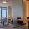 a room with a table chairs and a window