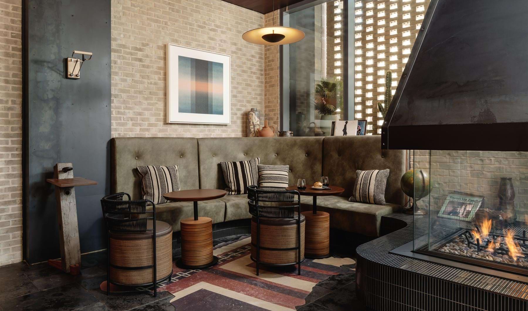 Find your perfect fit at Sienna at the Thompson a room with a fireplace and a table with a fire in it