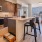 a kitchen with a bar and chairs
