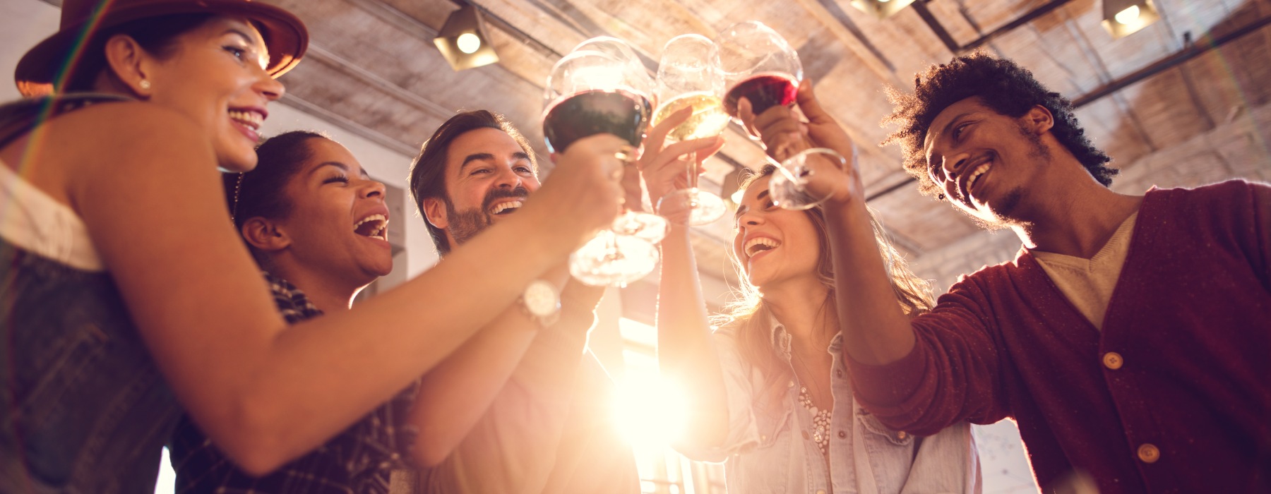 Five friends cheering with wine glasses