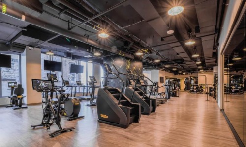 fitness center with open spaces and bright lighting through the windows